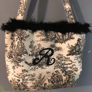 Black and White purse with the initial “ R”